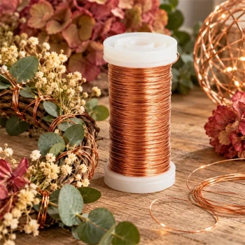 Kobberfarvet myrtetråd på hvid spole ved rustik blomsterdekoration med eucalyptus, tørrede blomster og kobbertråd.