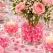 Raindrops Rosa dekorationsdråber i glasvase med lyserøde roser og hvide blomster som romantisk bordpynt.